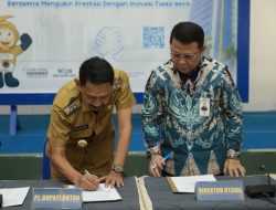 Pj Bupati Buton Teken Perjanjian Kerjasama Penerbitan Kartu Kredit Pemerintah Daerah